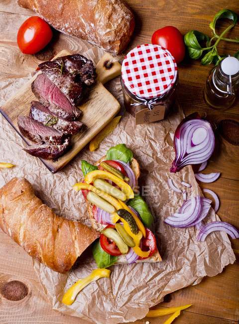 Steak sandwich on paper — Stock Photo