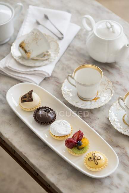 Elevated view of table setting with Petite fours — Stock Photo