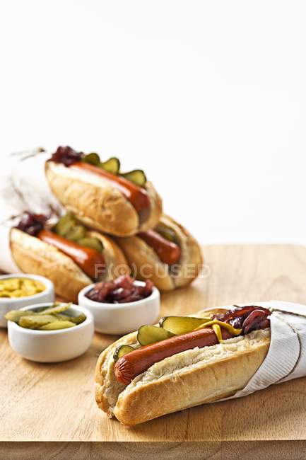 Hot dogs in rolls with gherkins — Stock Photo