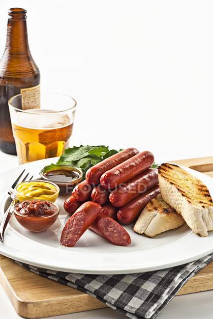 Sausages with grilled bread — Stock Photo
