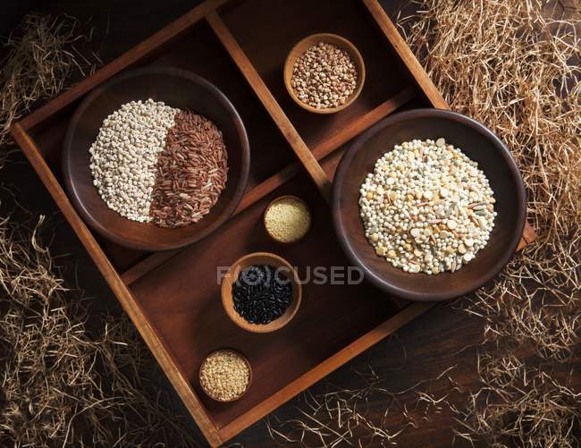 Grains in wooden bowls — Stock Photo
