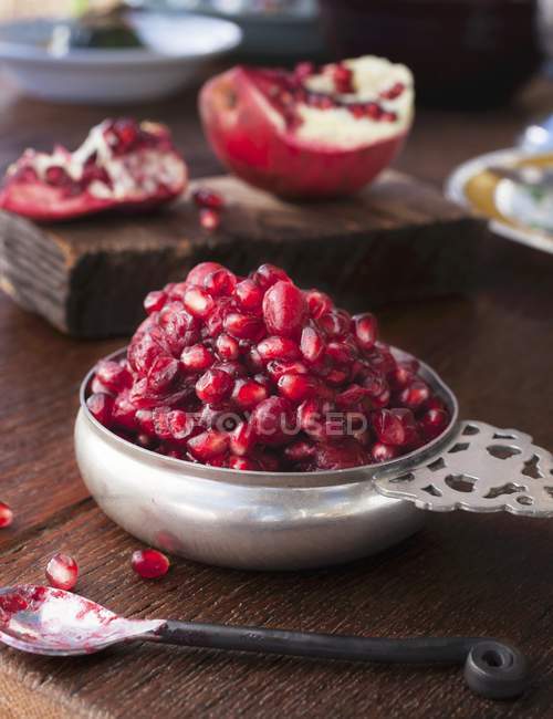 Fresh pomegranate seeds in bowl — Stock Photo