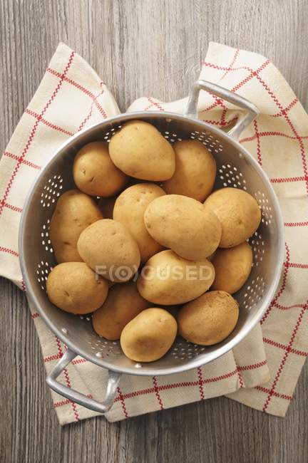 Fresh Potatoes in colander — Stock Photo
