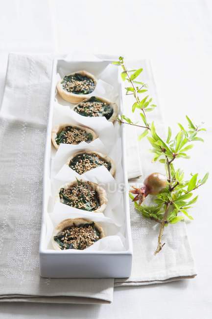 Espinacas y tartaletas de semillas de sésamo - foto de stock