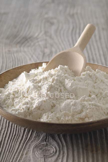 Flour in a wooden bowl — Stock Photo