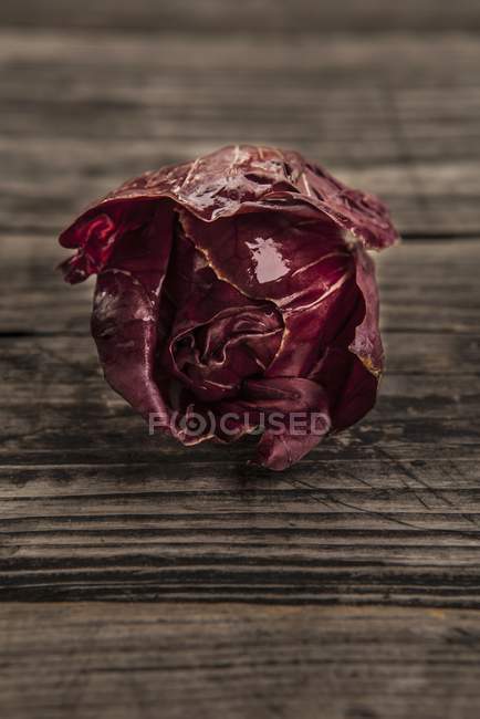 Fresh radicchio on an old wooden table — Stock Photo