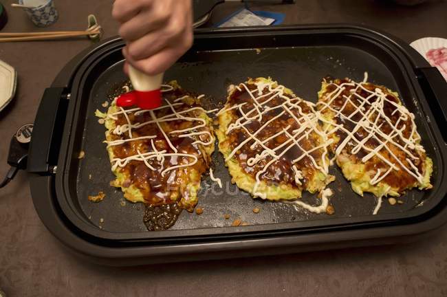 Japanese pancakes on a hot tray — Stock Photo