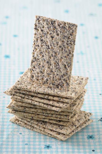 Stack of poppy seed crackers — Stock Photo