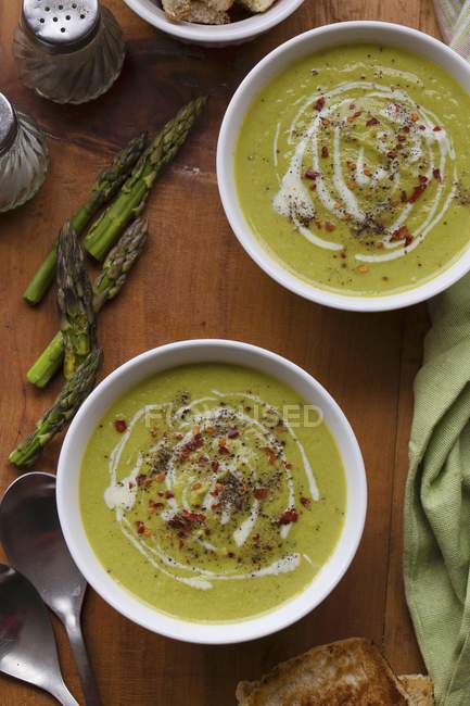 Green asparagus soup in bowls — Stock Photo