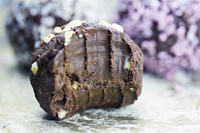 Closeup view of half eaten truffle praline — Stock Photo