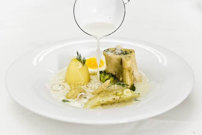 White borscht with white cabbage, potatoes and egg on white plate — Stock Photo