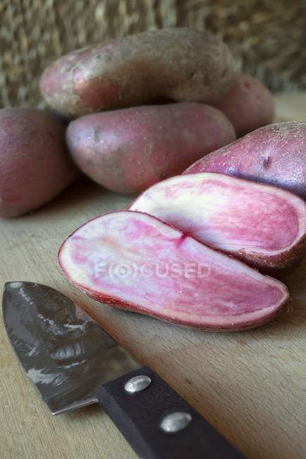 Whole and halved Red Emmalie potatoes — Stock Photo