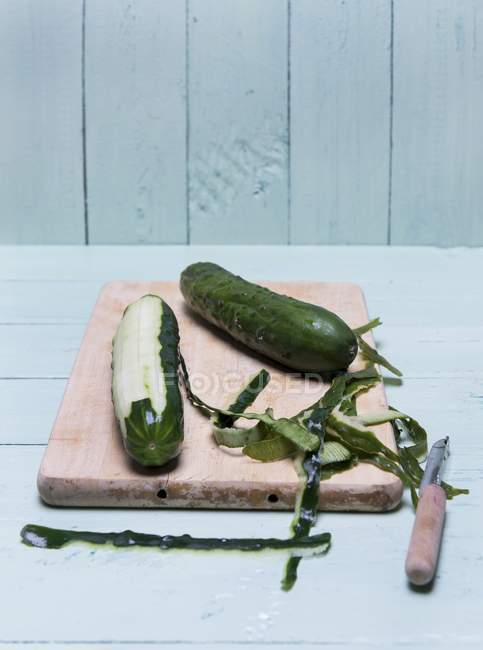 Fresh partly peeled cucumbers — Stock Photo