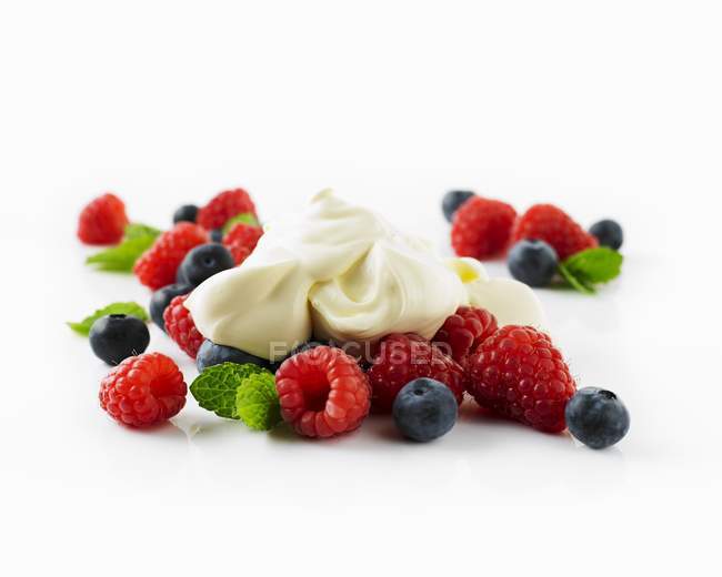 Sour creme on fresh summer berries — Stock Photo