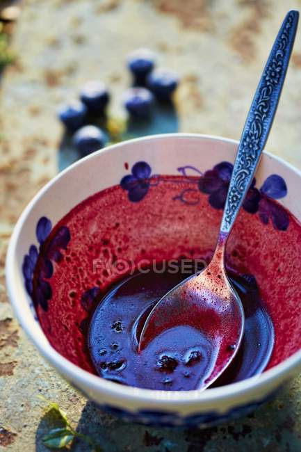 Closeup view of remains of blueberry soup in a bowl — Stock Photo