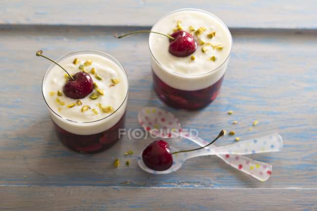 Cherry dessert with cream — Stock Photo