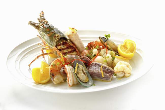 Closeup view of large platter of seafood on white surface — Stock Photo