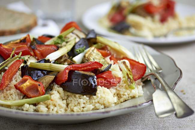 Couscous with aubergines on plate — Stock Photo