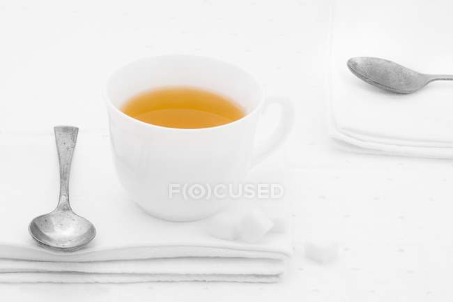 Xícara de chá em guardanapo de tecido branco — Fotografia de Stock