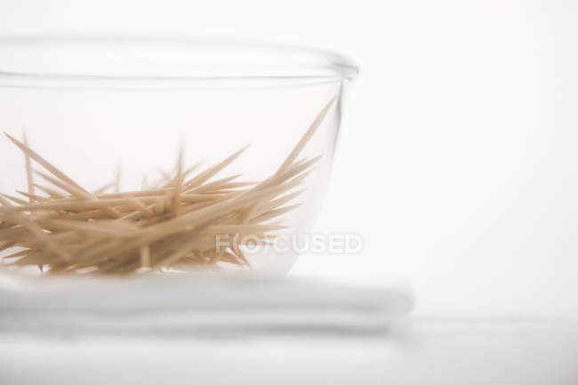 Closeup view of a glass bowl of toothpicks — Stock Photo