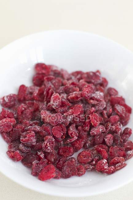Dried cranberries in bowl — Stock Photo