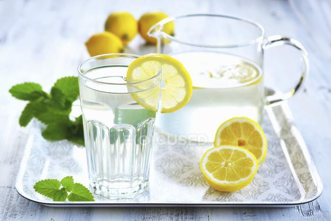 Lemon water with mint leaves — Stock Photo
