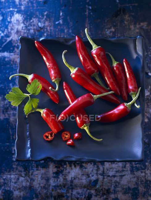 Red chilli peppers with parsley — Stock Photo