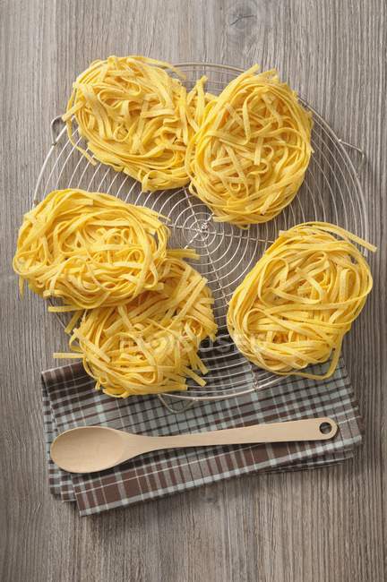Dry uncooked linguine pasta nests — Stock Photo