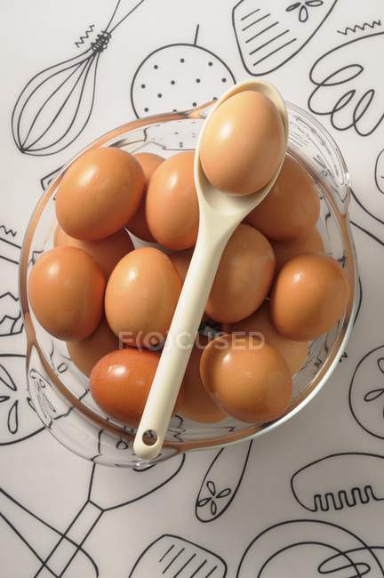 Chicken eggs in glass bowl — Stock Photo