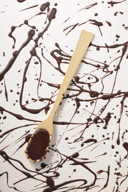 Chocolate glaze with wooden spoon — Stock Photo