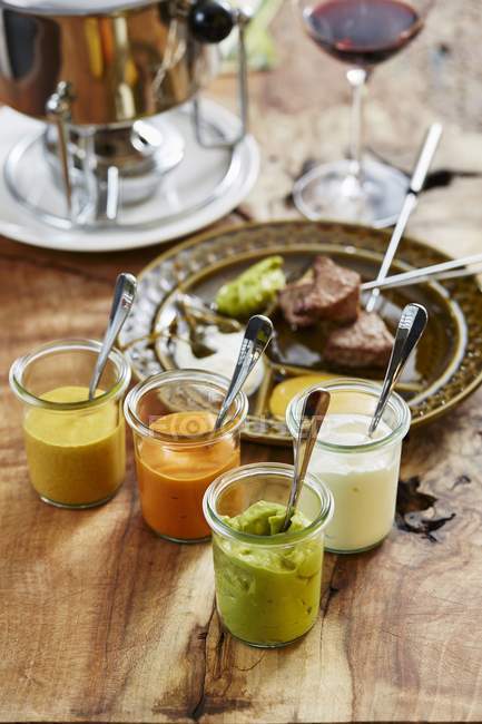Meat fondue and sauces — Stock Photo
