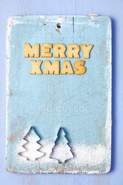 Christmas greetings with biscuits — Stock Photo