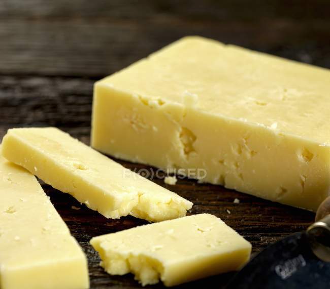 Cheddar cheese on wooden — Stock Photo