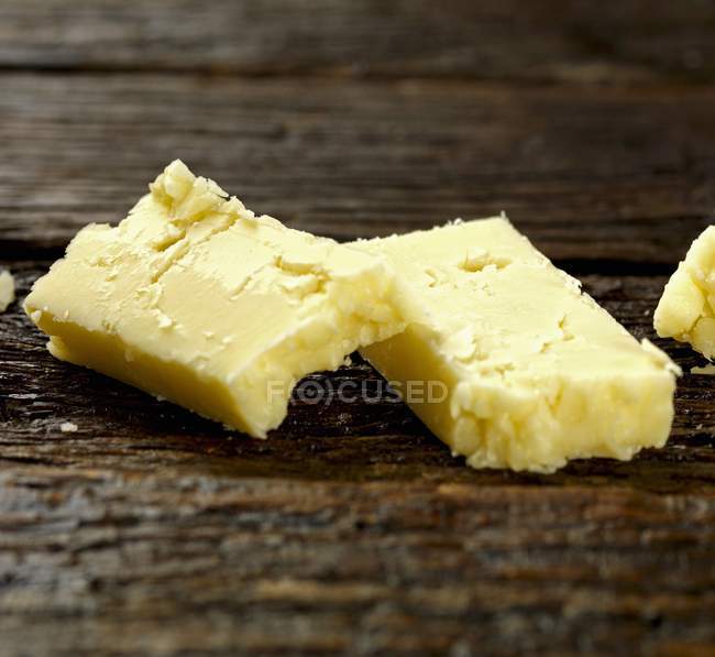 Cheddar cheese pieces — Stock Photo