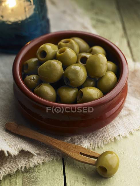 Pitted green olives in bowl — Stock Photo