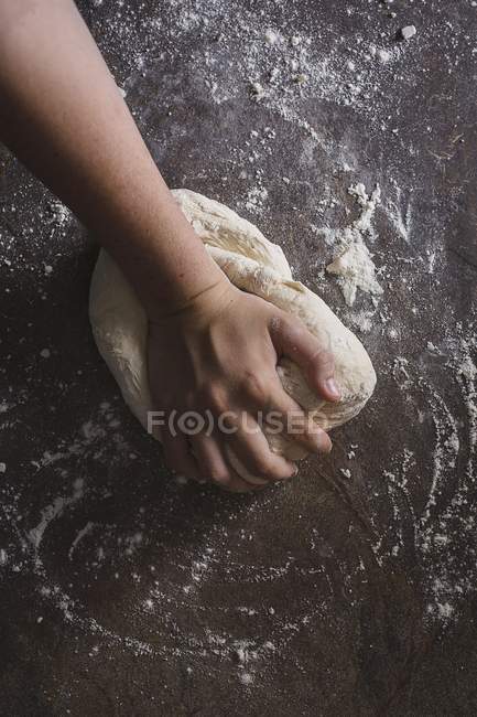 Kneading pizza dough — Stock Photo