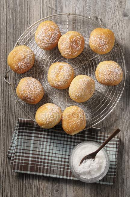 Sugared doughnuts on rack — Stock Photo
