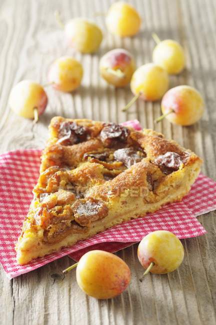Slice of yellow plum tart — Stock Photo