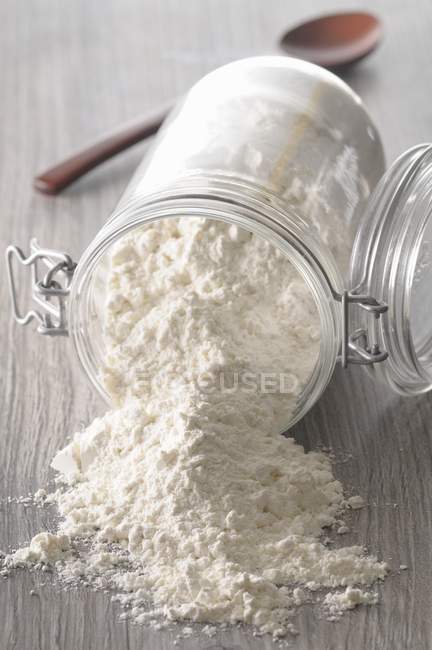 Flour in overturned jar — Stock Photo