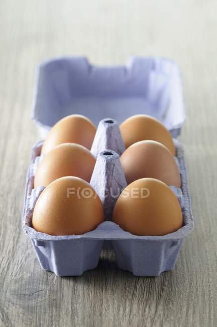 Fresh eggs in egg box — Stock Photo