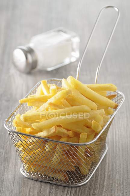 French fries in deep-frying basket — Stock Photo