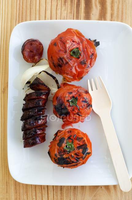 Grilled chorizo and tomatoes — Stock Photo