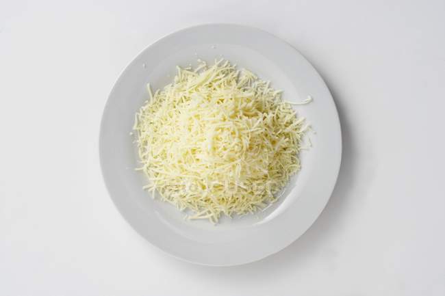 Plate of grated cheese — Stock Photo