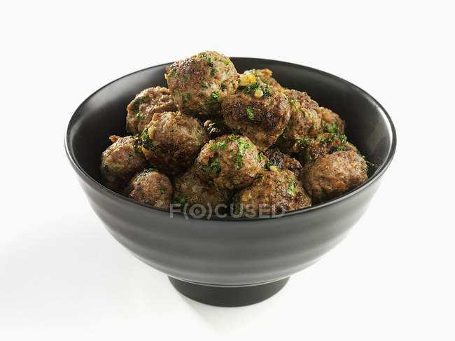 Bowl of meatballs with herbs — Stock Photo