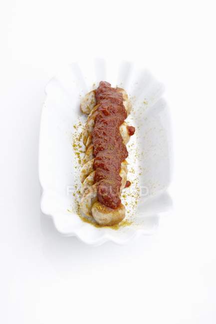 Curried sausage with ketchup — Stock Photo