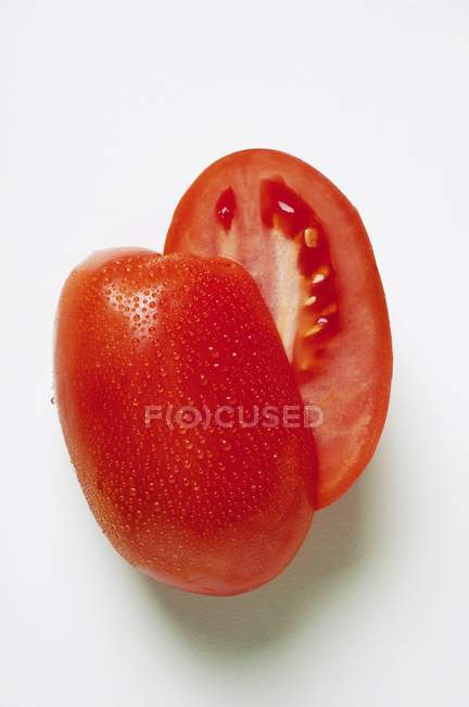Plum tomatoes with water — Stock Photo
