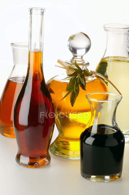 Various types of oil and balsamic vinegar in glass carafes — Stock Photo