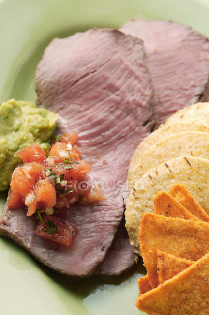 Roasted beef with tomato salsa — Stock Photo