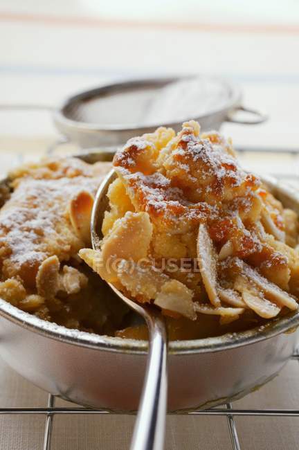 Closeup view of apple crumble with icing sugar — Stock Photo