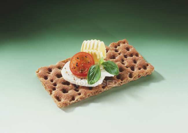 Crispbread on green background — Stock Photo